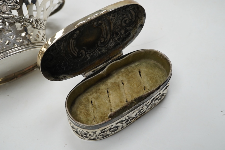 An Edwardian silver 'Reynold's Angels' silver canister, William Comyns, London, 1902, 90mm, together with a silver table perpetual lighter, silver bonbon basket and silver ring box. Condition - poor to fair